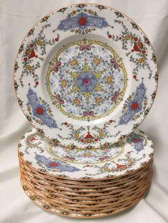 four plates stacked on top of each other with different designs and colors in the middle