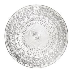 a white plate with an intricate design on the rim and bottom, sitting in front of a white background