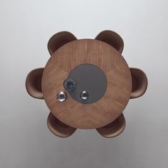 an overhead view of a wooden table with two metal knobs on the center piece