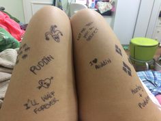 the legs are covered with tattoos and writing on their thighs, which read random things