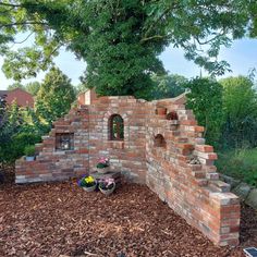 an old brick wall is built into the ground