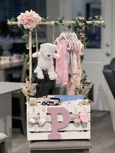 a baby's first birthday display with teddy bears and clothes hanging from the rack