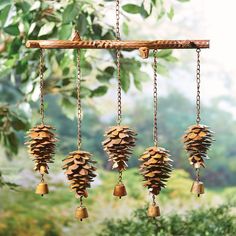 a wind chime with pine cones hanging from it