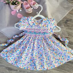 Celebrate Your Baby's Special Day In Style With Our Floral Smocked Embroidered Dress. Beautifully Crafted Garment That Exudes Elegance And Charm. Timeless Design | Vintage Victorian Floral Print | No Lined | Not See-Through. Details : - Breathable 100% Cotton. - Peter Pan Collar And Puffy Sleeves. -Precious Turquoise Rose-Buds And Pink Zic Zac Hand Smocking Across The Chest. - Matching Buttons To Assist With Dressing On A Back. - Adjustable Waist Tie. Runs True To Size. ! ! Matching Bloomers For Toddler Girls Easter Dresses, Easter Smocked Dress, Dresses For Baby Girl, Girl Easter Dress, Girls Easter Dress, Smocking Dress, 1st Birthday Dress, Girl Portraits