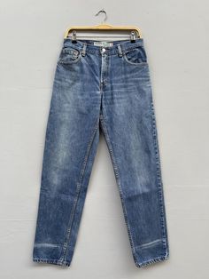 "REMINDER: THIS IS USED CLOTHING PLEASE DO NOT EXPECTED IT LIKE TO BE NEW OR IN PRISTINE CONDITION Feel free to contact me for any question. I'll assist you with my pleasure. Size 29 Vintage Levis 550 Distressed Jeans Levis High Rise Mid Wash Denim Levis Y2K Zipper Fly Relaxed Fit Classic Girlfriend Jeans W29 L28 Made In Columbia *All measurements are taken with the garment laying flat & doubled. Measurement in inches. We recommend giving yourself an extra few inches for ease of fit Size On Tag: 10L but fits more like: W29 Waist :- 29\" Rise :- 12\" Thighs :- 26\" Hips :- 42\" Inseam :- 32\" Length :- 42\" Leg opening :- 14\" CONDITIONS: Distressed, fold defect and ripped (KINDLY REFER TO THE PICTURES ATTACHED) Excellent Vintage Conditions. Please pay close attention to measurements provid Levis Vintage, Jeans Levis, Levis 550, Girlfriend Jeans, Used Clothing, Vintage Levis, Levis Jeans, Denim Wash, Distressed Jeans