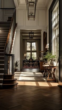 the sun shines through the windows in an elegant house with wood floors and stairs