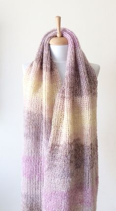 "This hand knit scarf is perfect and cozy accessory to keep you warm and stylilsh. This knit scarf is super large and wide made with softest and airy soft angora wool The scarf is long to make two loops, its very soft and comfortable. Material: extra soft and very light angora wool Color: Light Shades of Purple Pastel Yellow and very light Beige Width: 60 cm / 24\" Care: Handwash in luke warm water, lay flat to dry. Can also be washed in a washing mashing at gentle cycle, do not tumble dry 100% Warm Cozy Scarves One Size, Chunky Knit Acrylic Scarf One Size, One Size Knitting Pattern For Acrylic Yarn Scarf, One-size Acrylic Yarn Scarf Knitting Pattern, One Size Scarf Knitting Pattern, Knitted Scarf For Cold Weather, One Size, Knitted Scarves For Cold Weather, Cozy Knitted Acrylic Scarves, Cozy Knit Scarf Knitting Pattern