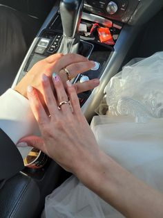 the bride and groom are getting ready to go on their wedding day in the car