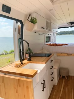 the interior of a tiny house with a bed and sink