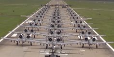 a large group of planes parked on the tarmac