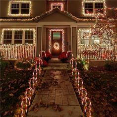 a house decorated with christmas lights and candy canes