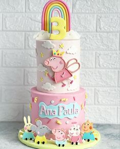 a three tiered cake with pep the pig and other animals on it's side