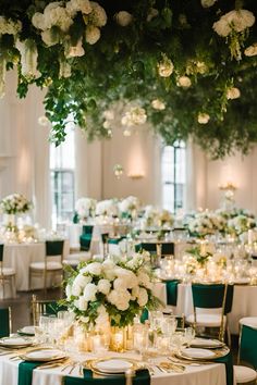 the tables are set with white and green linens, candles, and flowers on them