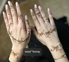 two hands with hendi designs on them