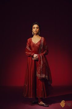 "A classic maroon full-sleeved\u00a0anarkali\u00a0with an\u00a0angrakha style neckline, punctuated with aari embroidery on the bodice, sleeves, and a shower of floral bootis\u00a0on the flared ends. Paired with a plain churidar\u00a0and an ornately hand-embroidered organza dupatta.\n\n\n\n Color\u00a0-  A\u00a0rich shade of\u00a0Maroon\n\n\n Fabric\u00a0-\u00a0Anarkali in pure Chanderi\u00a0silk, churidar in\u00a0pure silk, dupatta in pure organza silk\n\n\nCollection Note\u00a0-\u00a0Distinguished by its creative\u00a0rendition of designs that\u00a0reflect a heritage steeped in artistry, the Tilfi Kala collection draws inspiration from the\u00a0mesmerising\u00a0intricacy\u00a0of old Mughal miniature art and architecture, bringing\u00a0it to life on textiles through masterful craftsmanship Banarasi Anarkali, Maroon Anarkali, Mughal Miniature, Anarkali Designs, Kurti Cotton, Shades Of Maroon, Women Kurti, Long Tunic Dress, Angrakha Style