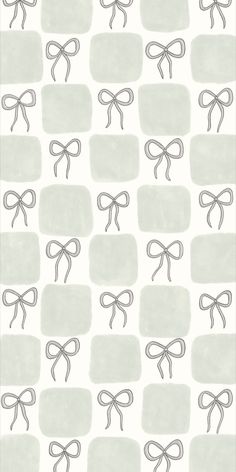 a white and gray wallpaper with bows on it