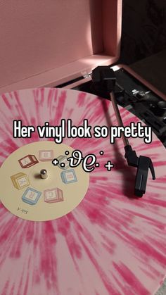 a pink and white record player with the words her vinyl look so pretty on it