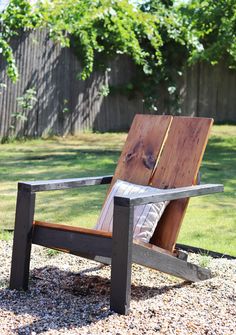 a wooden chair sitting on top of a gravel field