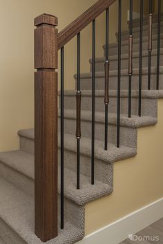 the stairs are made of wood and have metal balustiers on each handrail