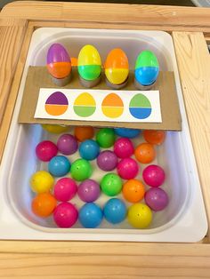 an egg tray with colored eggs in it