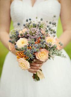 a bride holding a bouquet of flowers in her hands