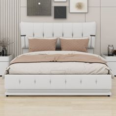 a white bed sitting in a bedroom on top of a hard wood floor