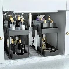 two black shelves holding bottles and soaps in a bathroom