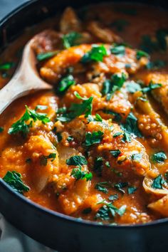 a close up of a pan filled with food and garnished with parsley