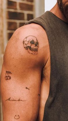 a man with a skull tattoo on his arm