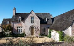 a large brick house with a black roof