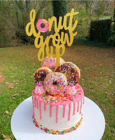 a cake with donuts and sprinkles on it that says donut grow