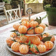 there are many oranges stacked on the table