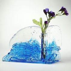 a blue vase with water and flowers in it