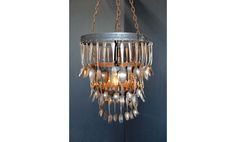 an old fashioned chandelier hanging from a chain with lights on it's sides