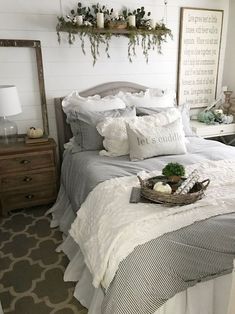 a bed with white sheets and pillows in a room