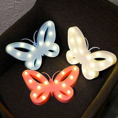 three light up butterflies sitting on top of a chair