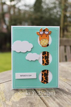 a close up of a card with a giraffe on the front and clouds on the back