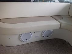 the inside of a boat with two speakers on it's back end and front seats