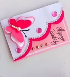 a pink and white birthday card with a butterfly on it