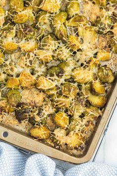 a casserole dish with brussel sprouts and cheese