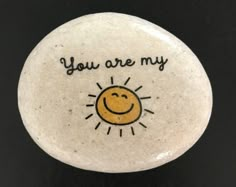 a white rock with an image of a smiling face and the words you are my on it