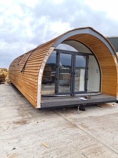 a large wooden structure sitting on top of a tarmac