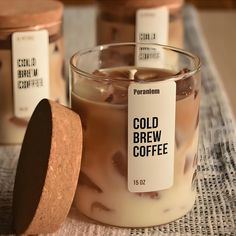 a glass jar filled with cold brew coffee sitting on top of a cloth covered table