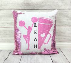 a pink sequin pillow with the words leap on it