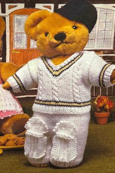 two teddy bears dressed up as baseball players and one is holding a plate with cookies