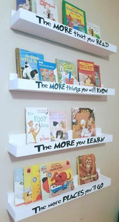 three white bookshelves with different types of children's books on them