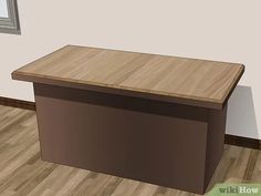 a wooden desk sitting on top of a hard wood floor next to a framed mirror