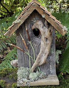 a birdhouse made out of wood and moss