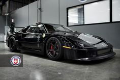 a black sports car parked in a garage