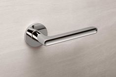 an image of a door handle on a stainless steel surface that looks like it has been brushed